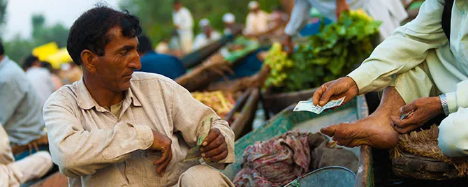 Cash transaction in Indian local market showing traditional payment method