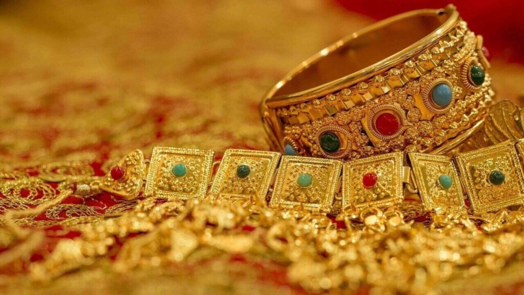 Close-up of gold bangles and ornaments representing gold demand, jewellery market and investment value