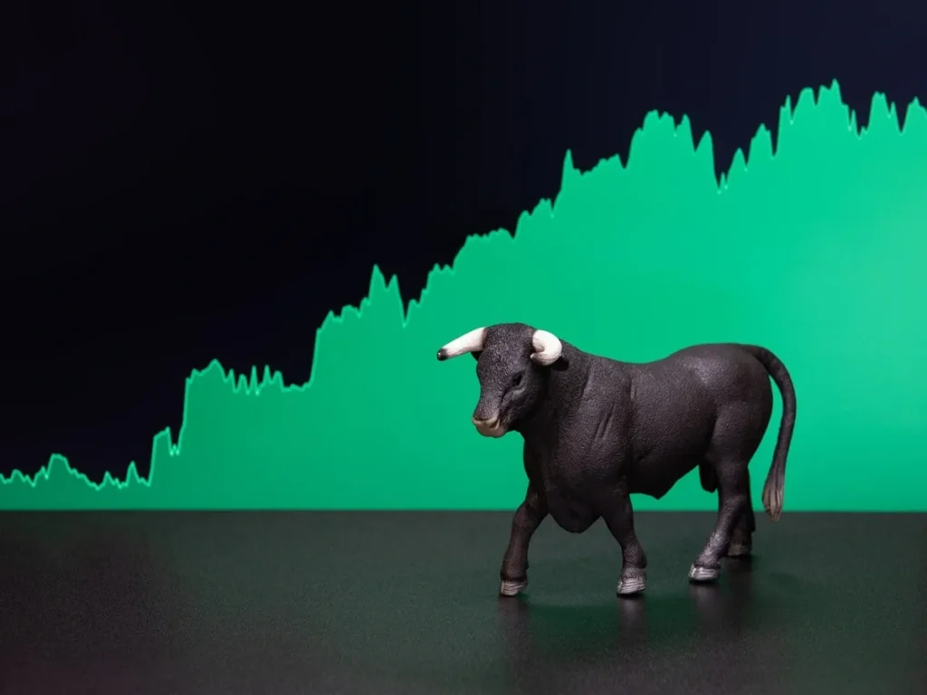 Stock market bull with rising green chart indicating sectors growth for 2026
